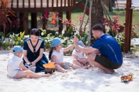 A CHILD’S DAY BEGINS WITH SUNLIGHT AND BAREFOOT STEPS ON SAND...